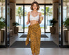 Woman in a white bikini top and tiger printed sarong
